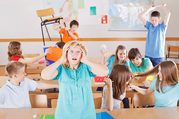 Uncontrollable pupils in classroom acting out, frustrated teacher tearing a hair out.